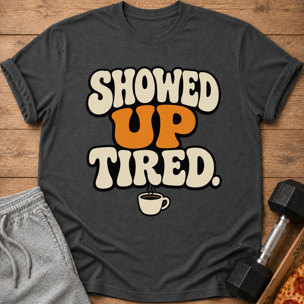 Dark gray t-shirt with text "SHOWED UP TIRED" and coffee cup graphic.