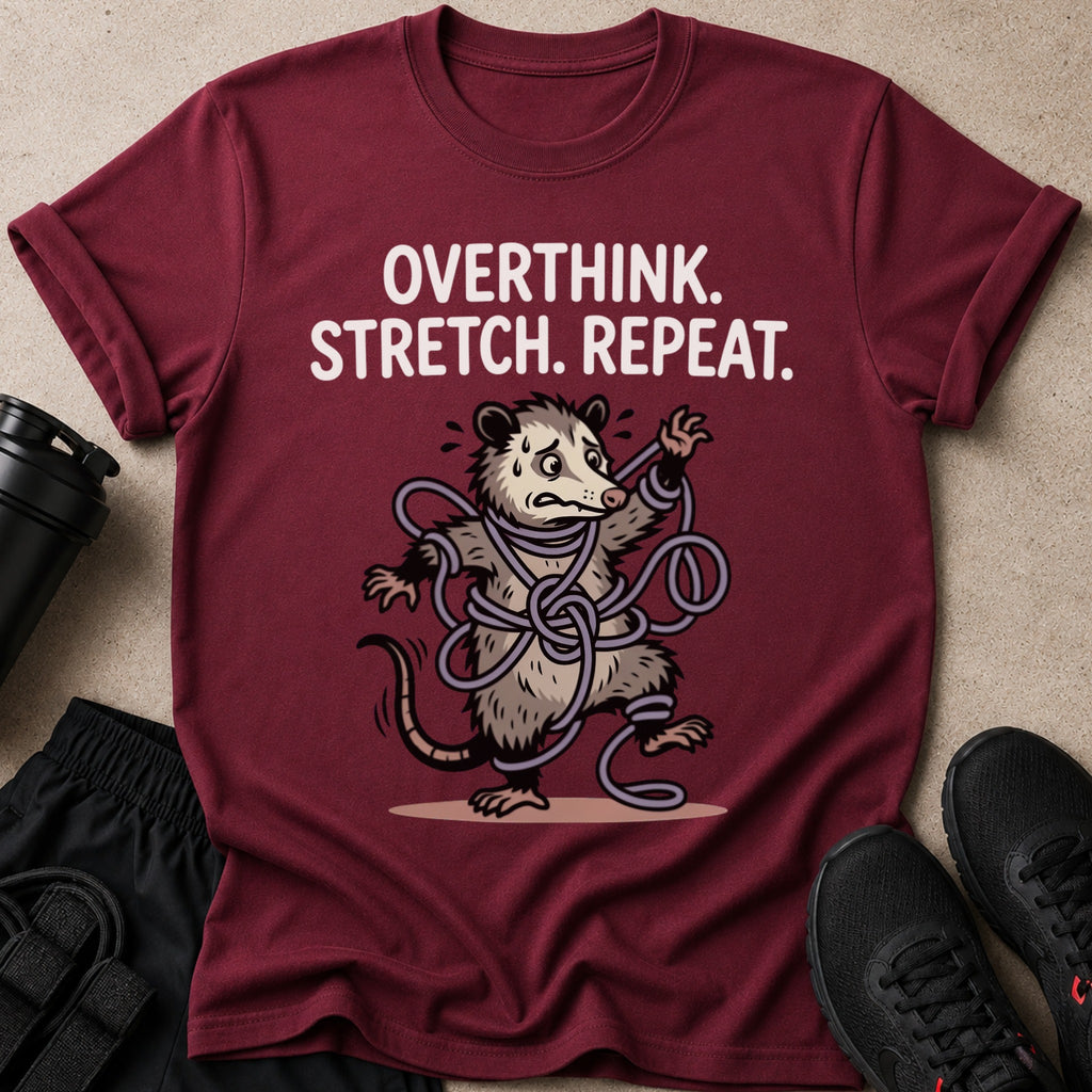 Maroon t-shirt with "Overthink. Stretch. Repeat." and a cartoon opossum tangled in rope.