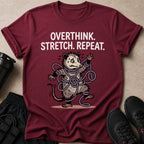 Maroon t-shirt with "Overthink. Stretch. Repeat." and a cartoon opossum tangled in rope.