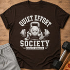 Brown t-shirt with "Quiet Effort Society No Hype Required" text and cartoon kettlebell.