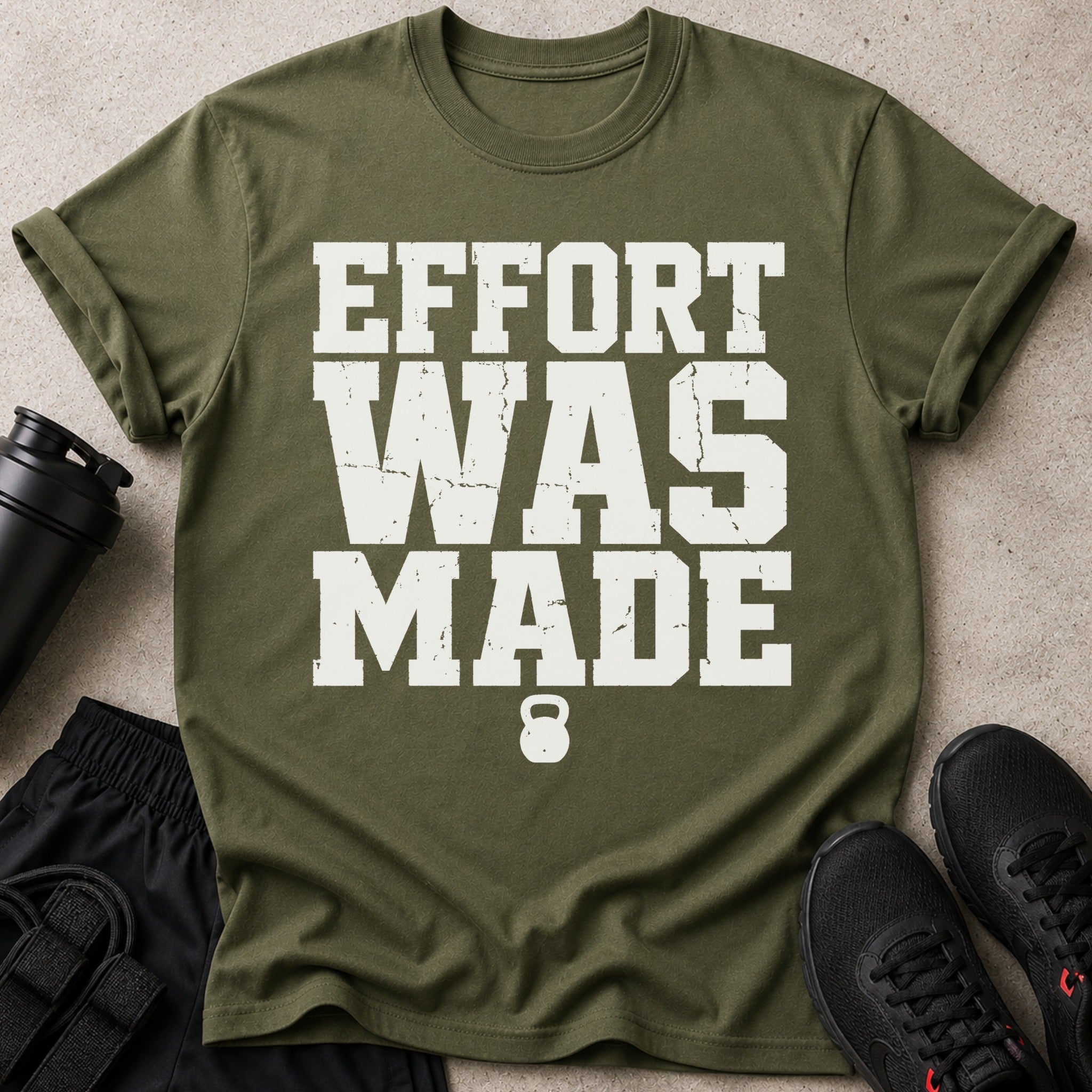 Green t-shirt with white text "EFFORT WAS MADE" and a kettlebell logo.