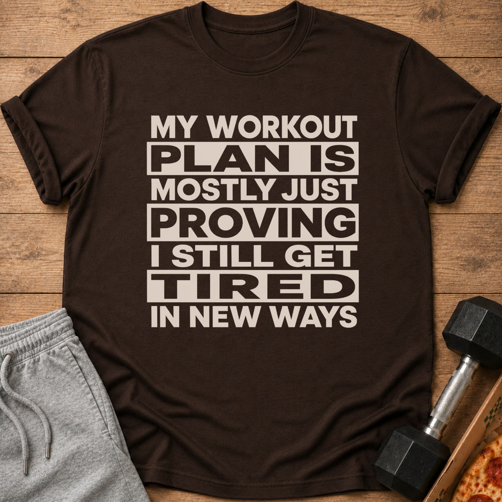 Brown t-shirt with "My workout plan is mostly just proving I still get tired in new ways" text.