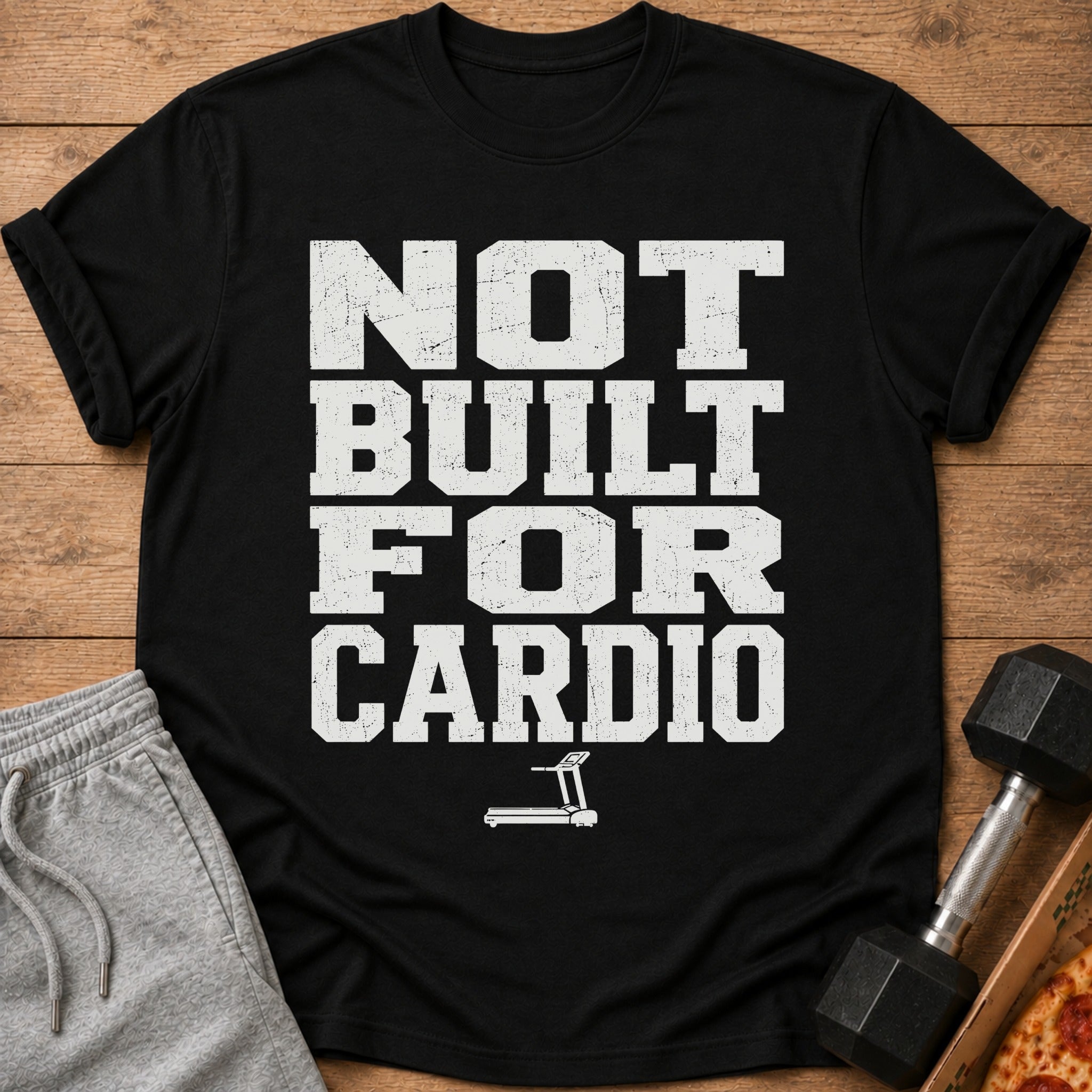 Black t-shirt with distressed white text reading "NOT BUILT FOR CARDIO" and a treadmill icon.