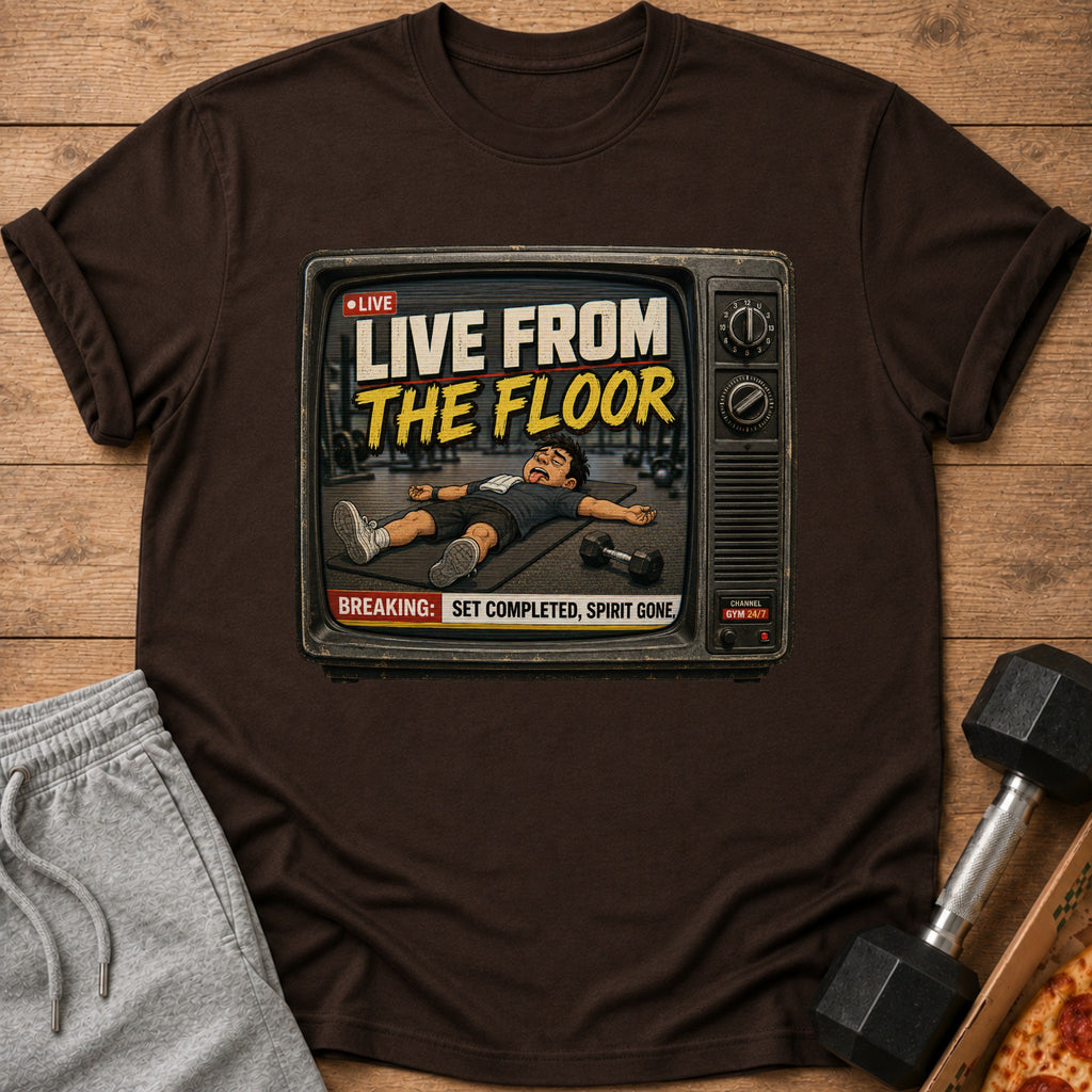 T-shirt graphic of a man lying on a mat with text "LIVE FROM THE FLOOR".