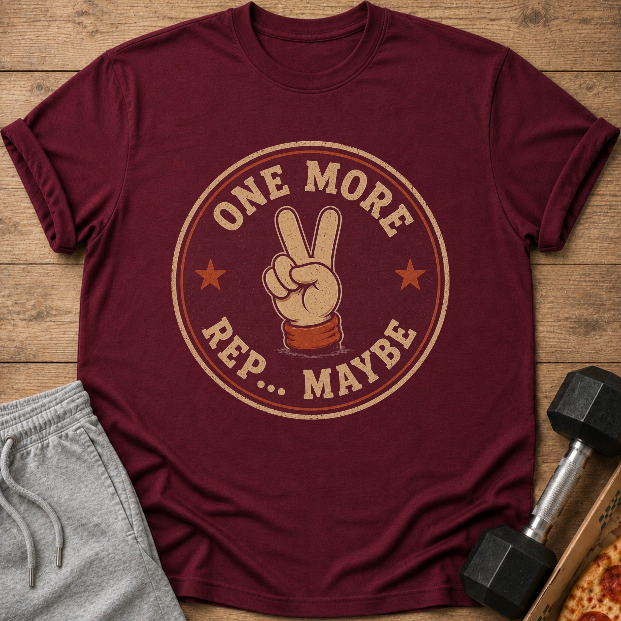 Maroon t-shirt with "ONE MORE REP... MAYBE" and peace sign graphic.