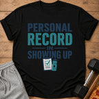 Black t-shirt with "Personal Record In Showing Up" text and gym icons.