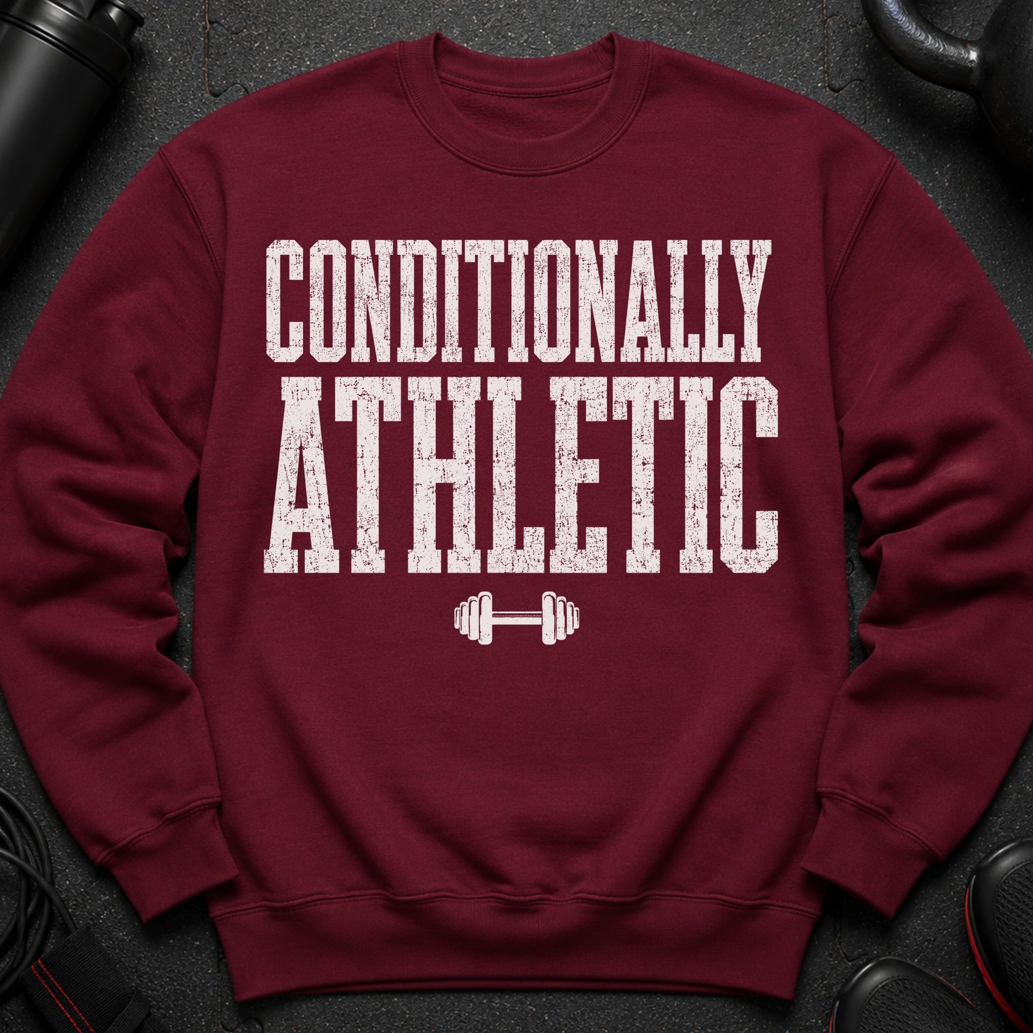 Maroon sweatshirt with white distressed text "CONDITIONALLY ATHLETIC" and barbell graphic.