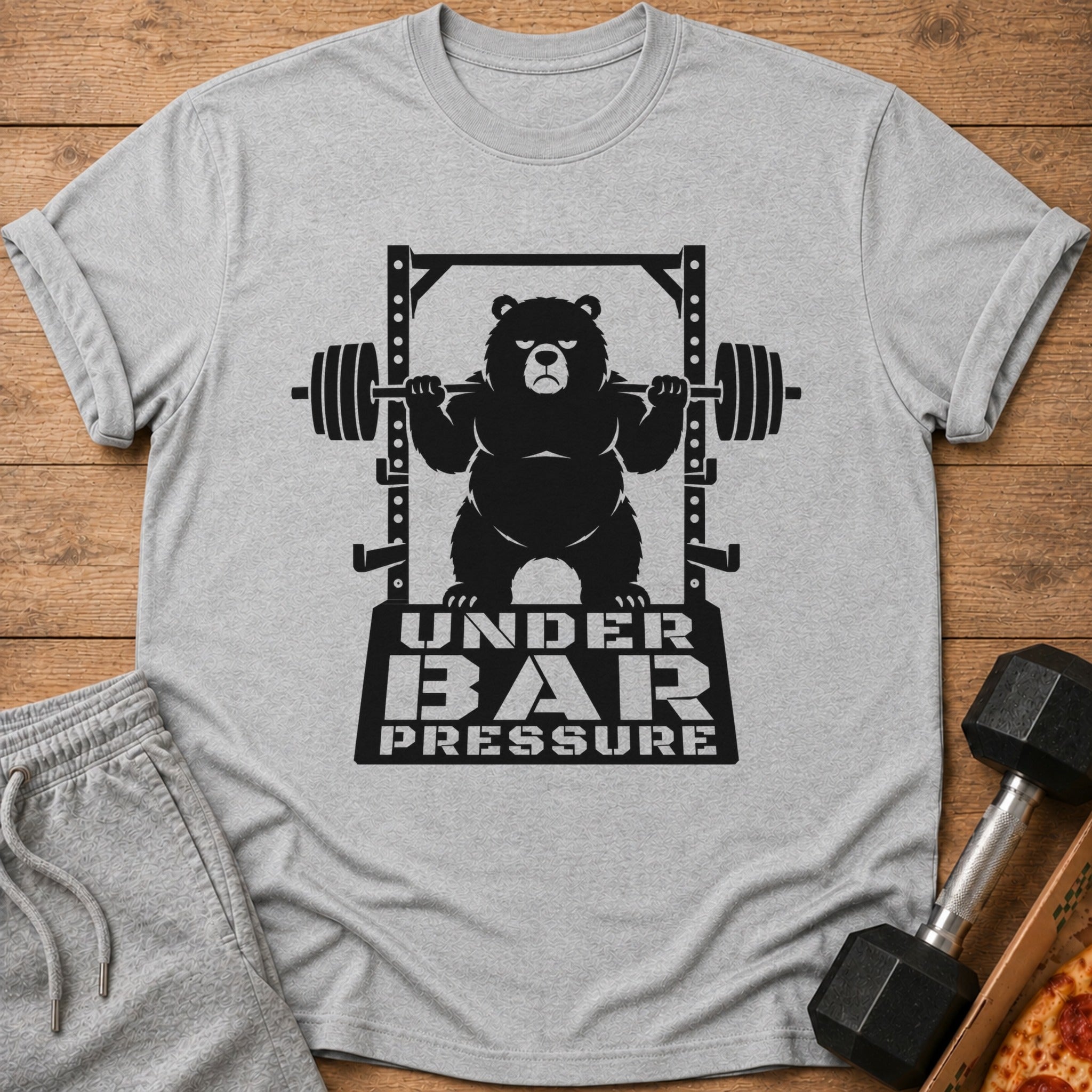 T-shirt graphic of a bear lifting weights with text "UNDER BAR PRESSURE".