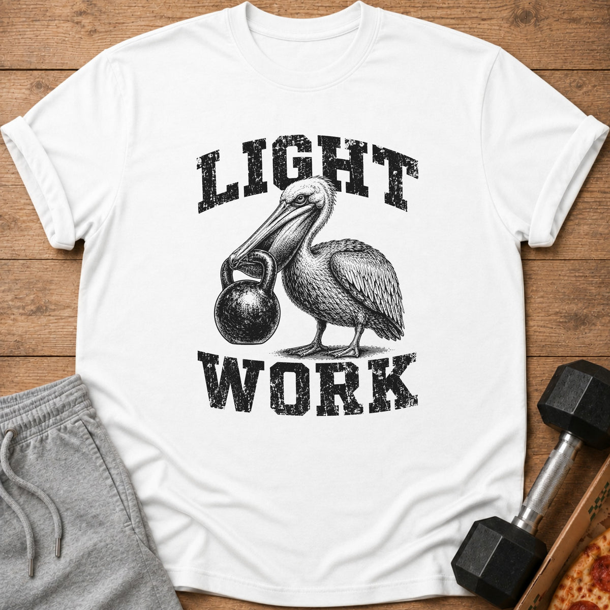 White t-shirt with pelican holding kettlebell and text "LIGHT WORK".