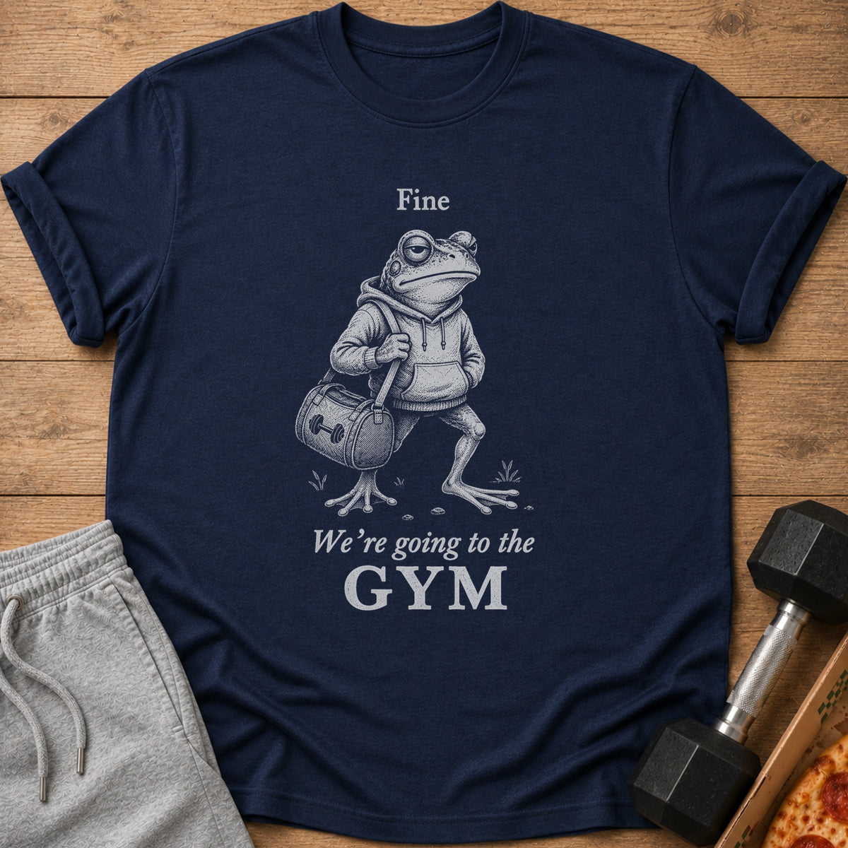 Navy t-shirt with a distressed graphic of a frog wearing a hoodie and carrying a gym bag, with text "Fine We're going to the GYM".