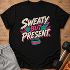 Black t-shirt with "Sweaty But Present" text and a colorful wristband graphic.