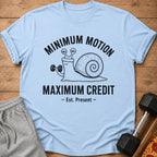 Light blue t-shirt with a snail lifting a dumbbell, text reads "MINIMUM MOTION MAXIMUM CREDIT".