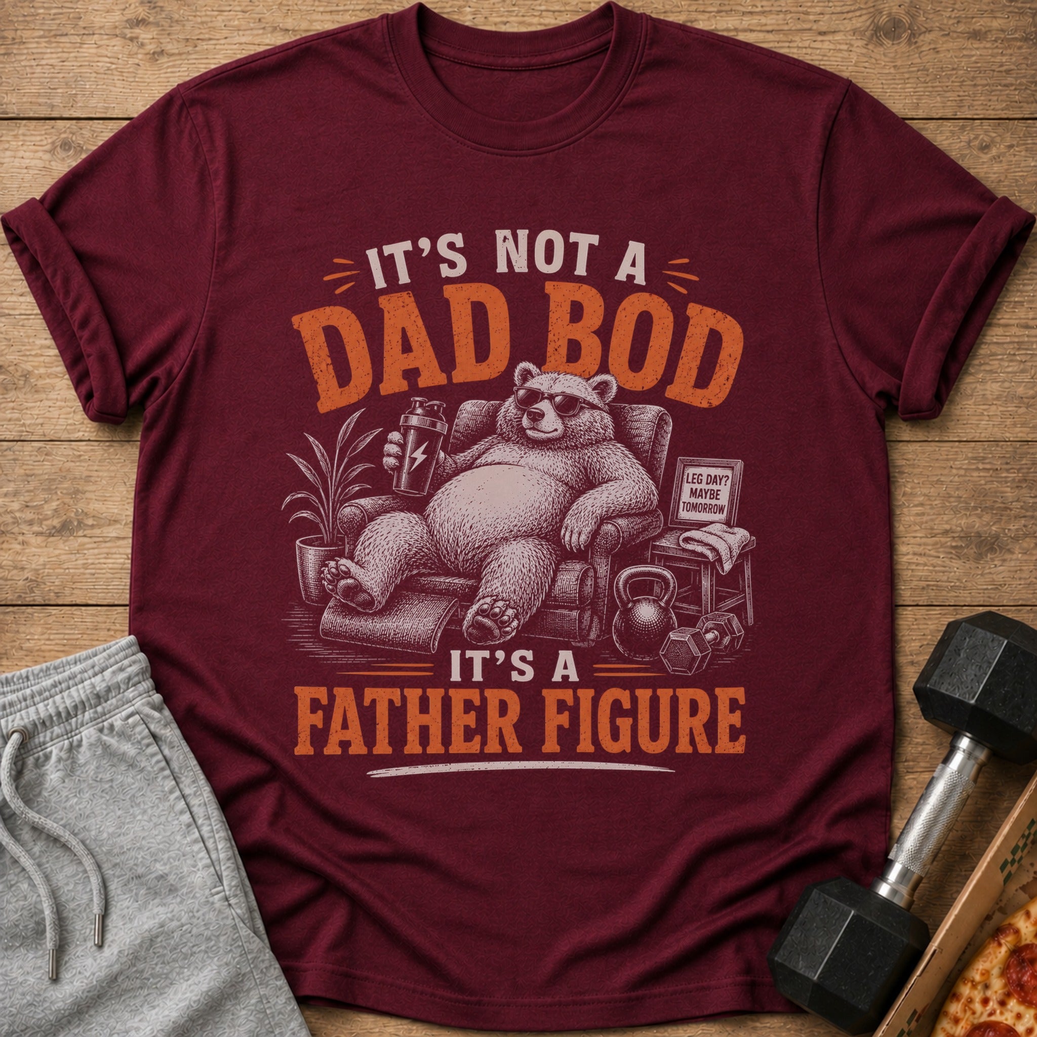 Maroon t-shirt with text "It's Not a Dad Bod. It's a Father Figure" and bear graphic.