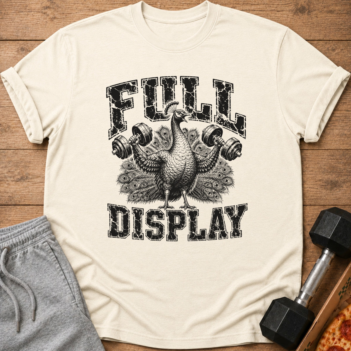Peacock lifting weights with "FULL DISPLAY" text on a light-colored shirt.