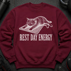 Maroon sweatshirt with a white graphic of a cat on a mat and the text "REST DAY ENERGY".
