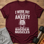 Maroon t-shirt with text "I WORK OUT SO MY ANXIETY HAS BIGGER MUSCLES" and cartoon kettlebell.