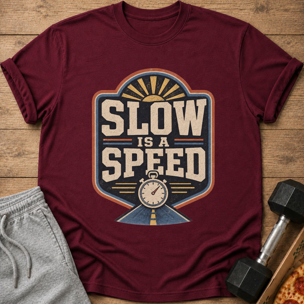 Maroon t-shirt with "Slow Is A Speed" graphic featuring a stopwatch and sun.