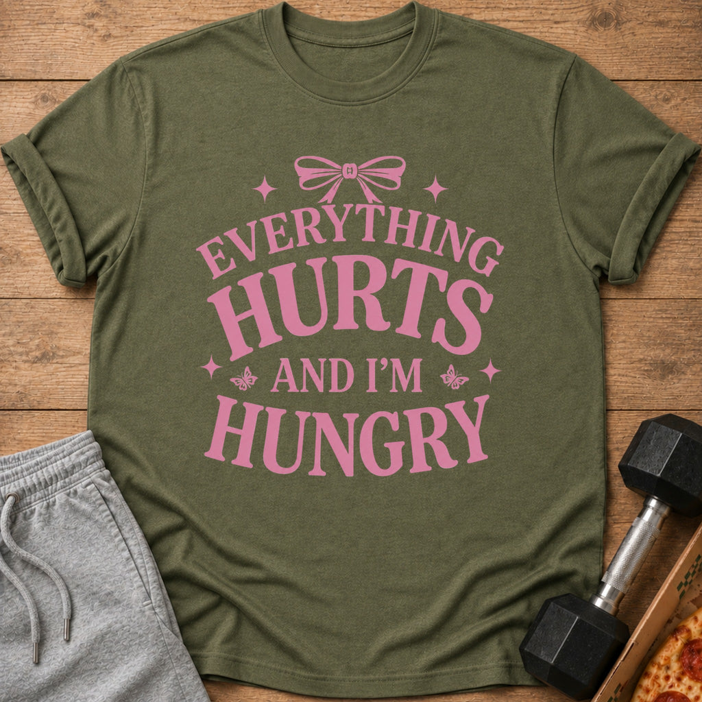Olive green t-shirt with pink text: "EVERYTHING HURTS AND I'M HUNGRY"