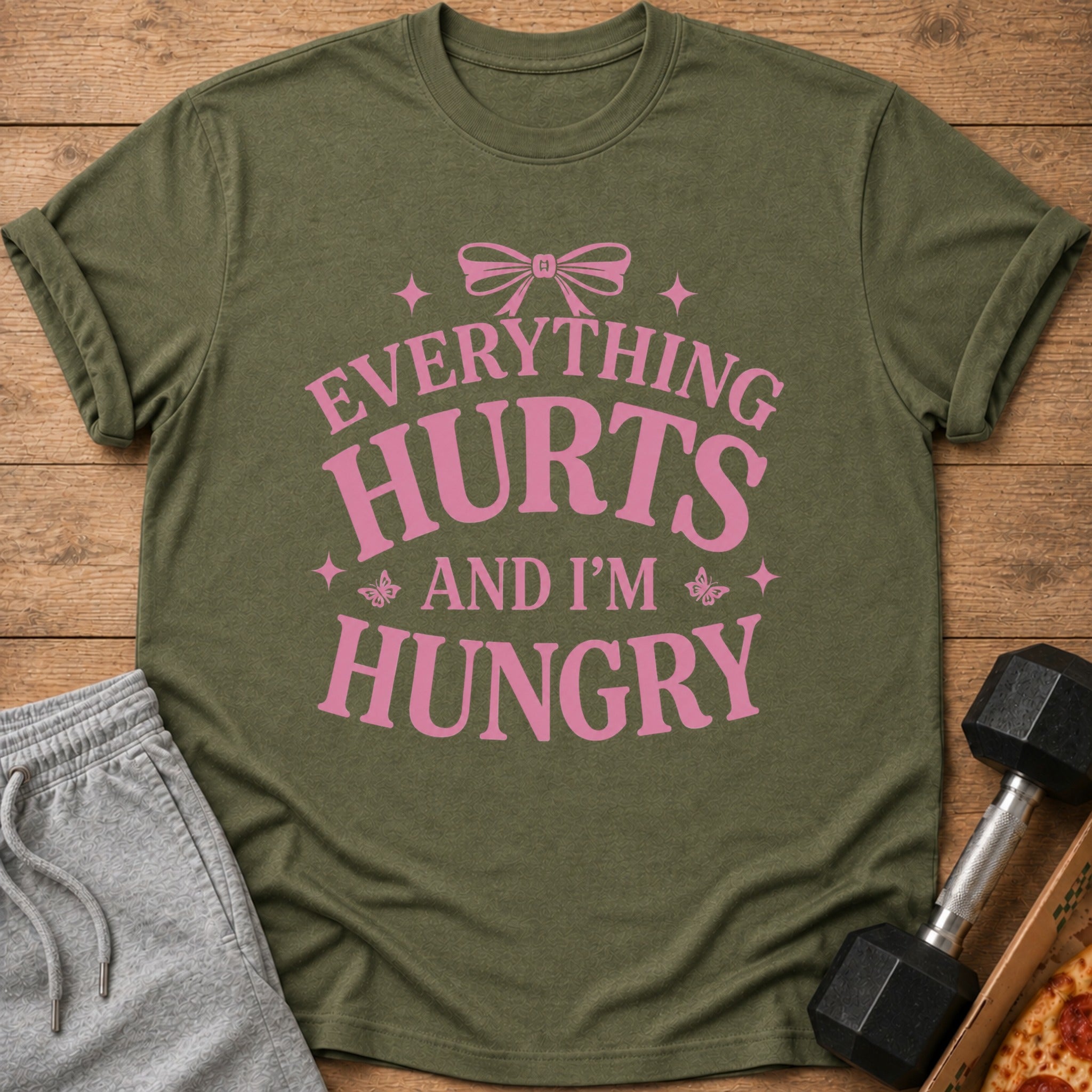 Olive green t-shirt with pink text: "EVERYTHING HURTS AND I'M HUNGRY"