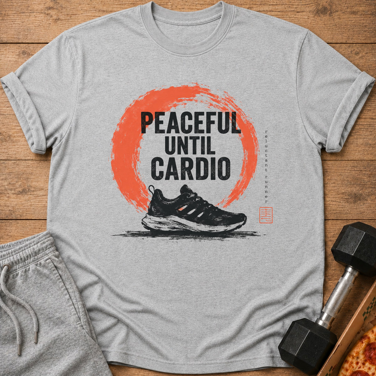 Gray t-shirt with "PEACEFUL UNTIL CARDIO" text, running shoe, and orange brush stroke.