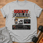Gray t-shirt with pixelated "Quest Failed Successfully" and workout stats.