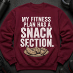 Maroon sweatshirt with text "MY FITNESS PLAN HAS A SNACK SECTION" and image of snacks.