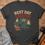 Dark grey t-shirt with "REST DAY LEGEND" text and cartoon character on couch.