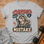 T-shirt with graphic of raccoon on elliptical, "Cardio Was A Mistake" text.