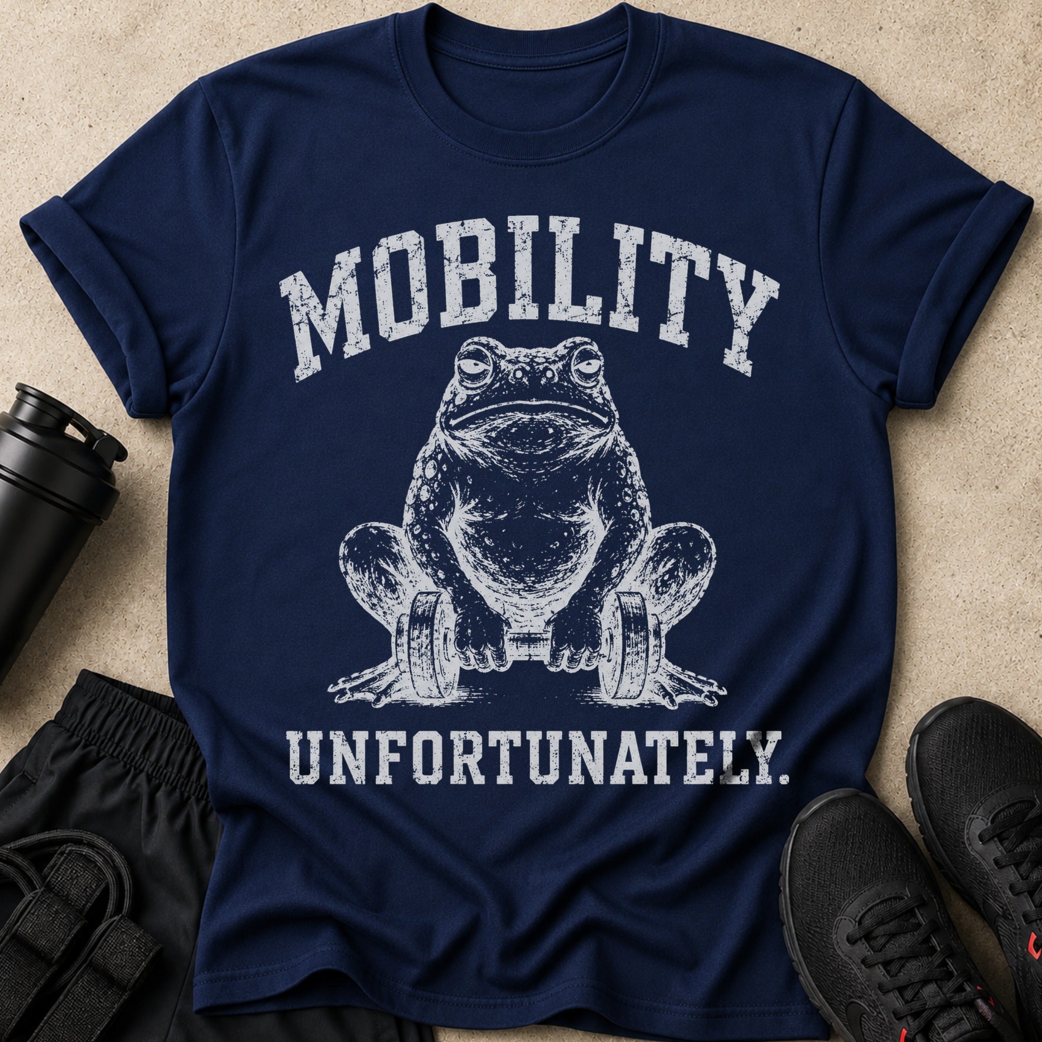 Navy t-shirt with distressed graphic of a frog lifting dumbbells, text reads "MOBILITY UNFORTUNATELY."