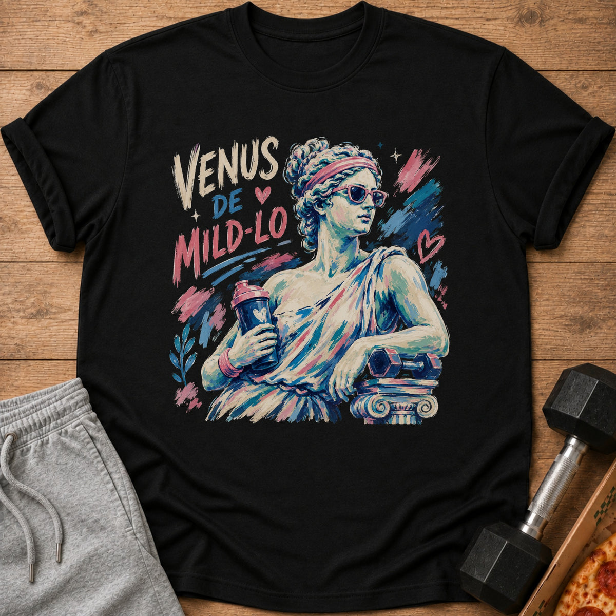 Black t-shirt with "Venus De Mild-Lo" text and illustration of statue holding shaker.