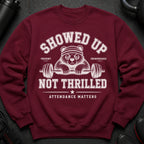 Maroon sweatshirt with a tired bear lifting a barbell, text reads "SHOWED UP. UNIMPRESSED. NOT THRILLED. ATTENDANCE MATTERS."