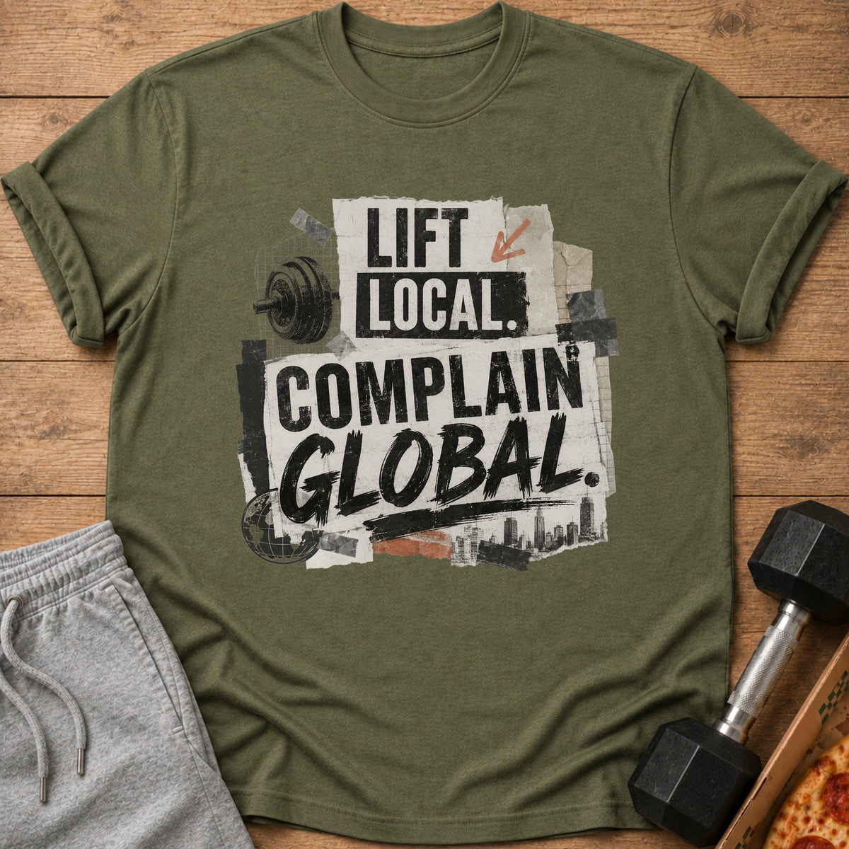 Olive green t-shirt with "Lift Local. Complain Global." text, barbell, and city skyline graphic.