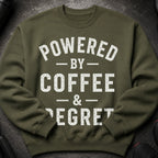 Olive green sweatshirt with white text: Powered by Coffee & Regret.