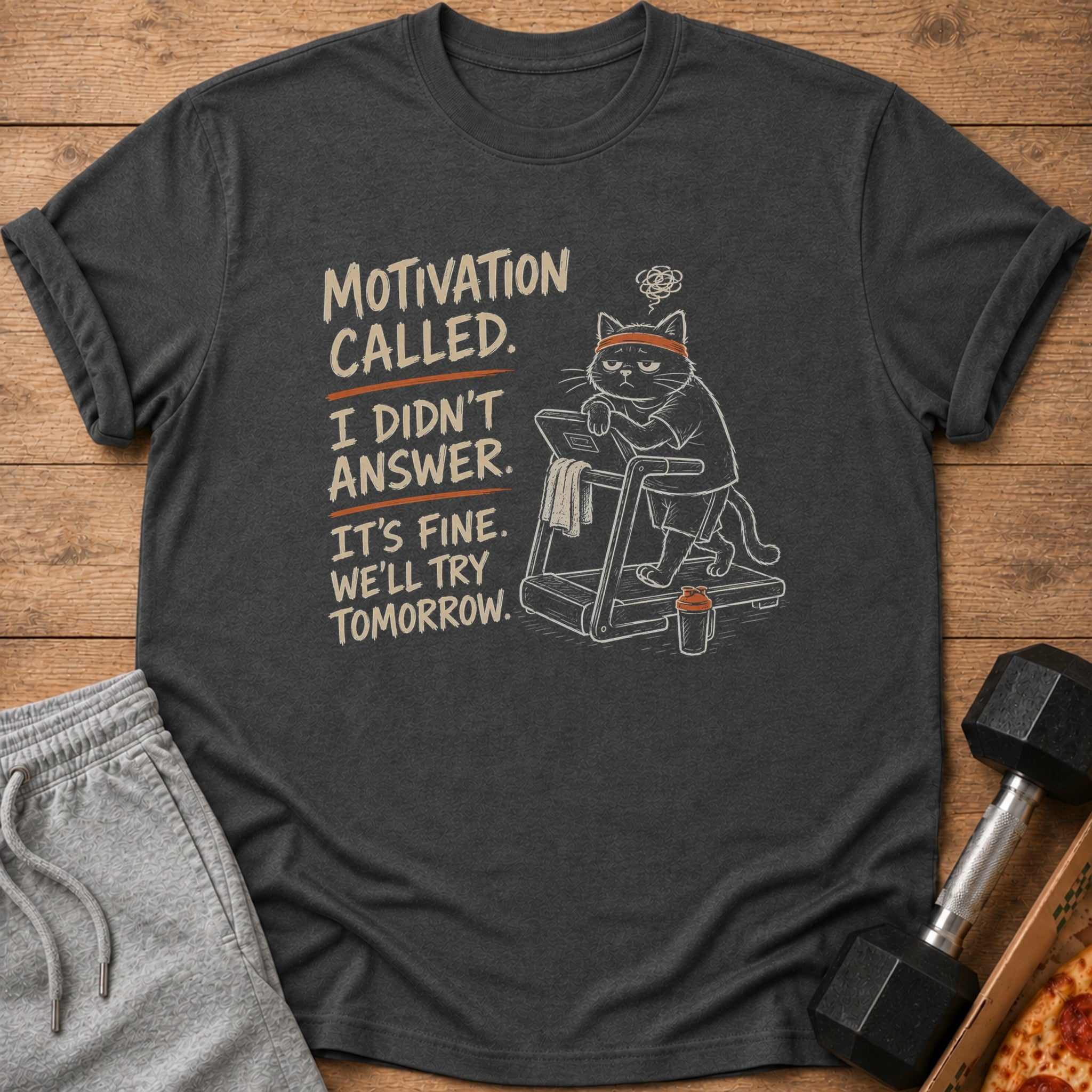 Dark grey t-shirt with text and a cartoon cat on a treadmill.