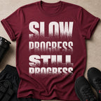 Maroon t-shirt with distressed text "SLOW PROGRESS STILL PROGRESS".