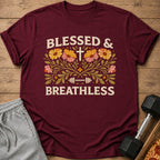 Maroon t-shirt with "BLESSED & BREATHLESS" text, cross, barbell, and floral design.