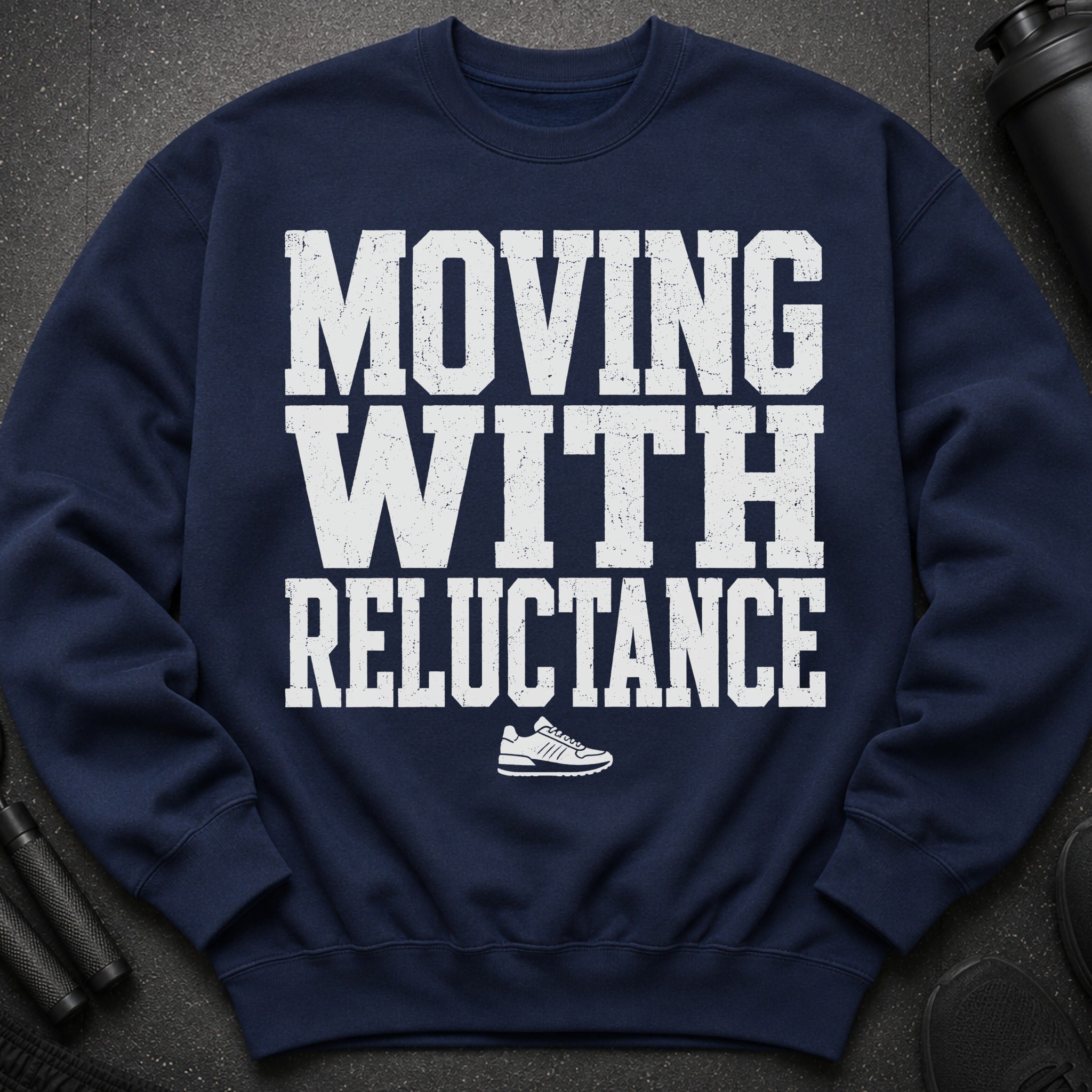 Navy sweatshirt with white text "MOVING WITH RELUCTANCE" and a sneaker icon.