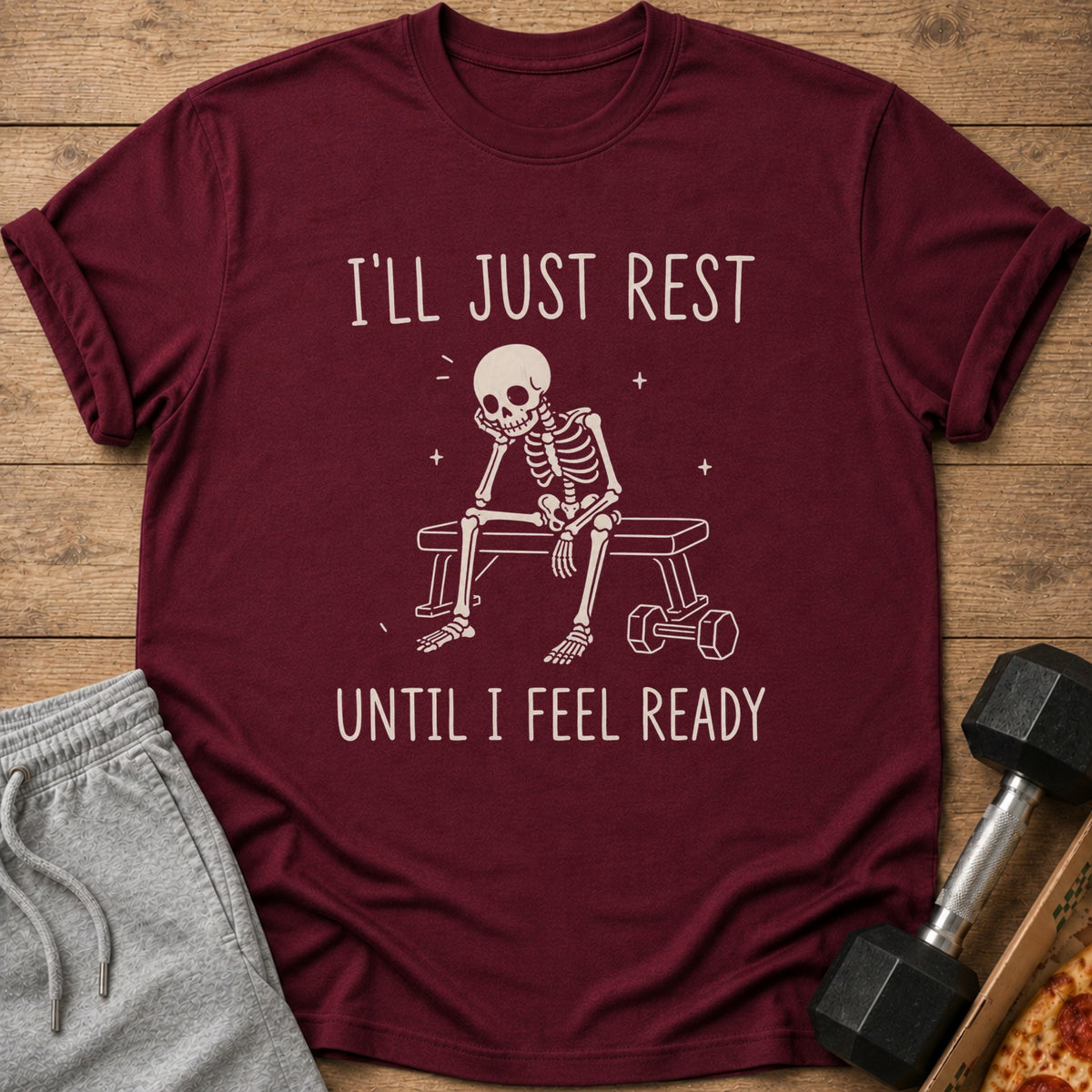 Maroon t-shirt with skeleton on bench and text "I'LL JUST REST UNTIL I FEEL READY".