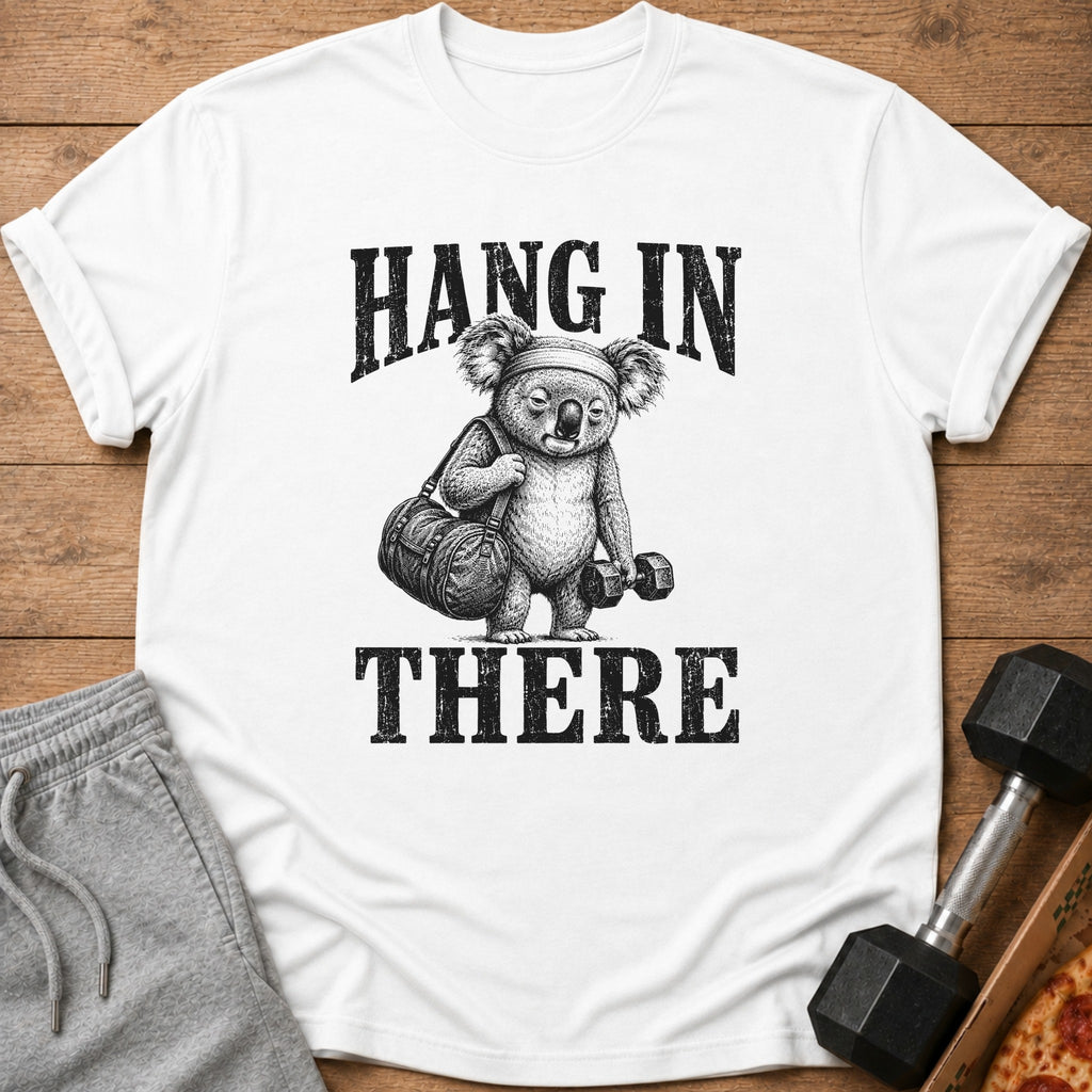 White t-shirt with a drawing of a koala holding a gym bag and dumbbell, text says "HANG IN THERE".