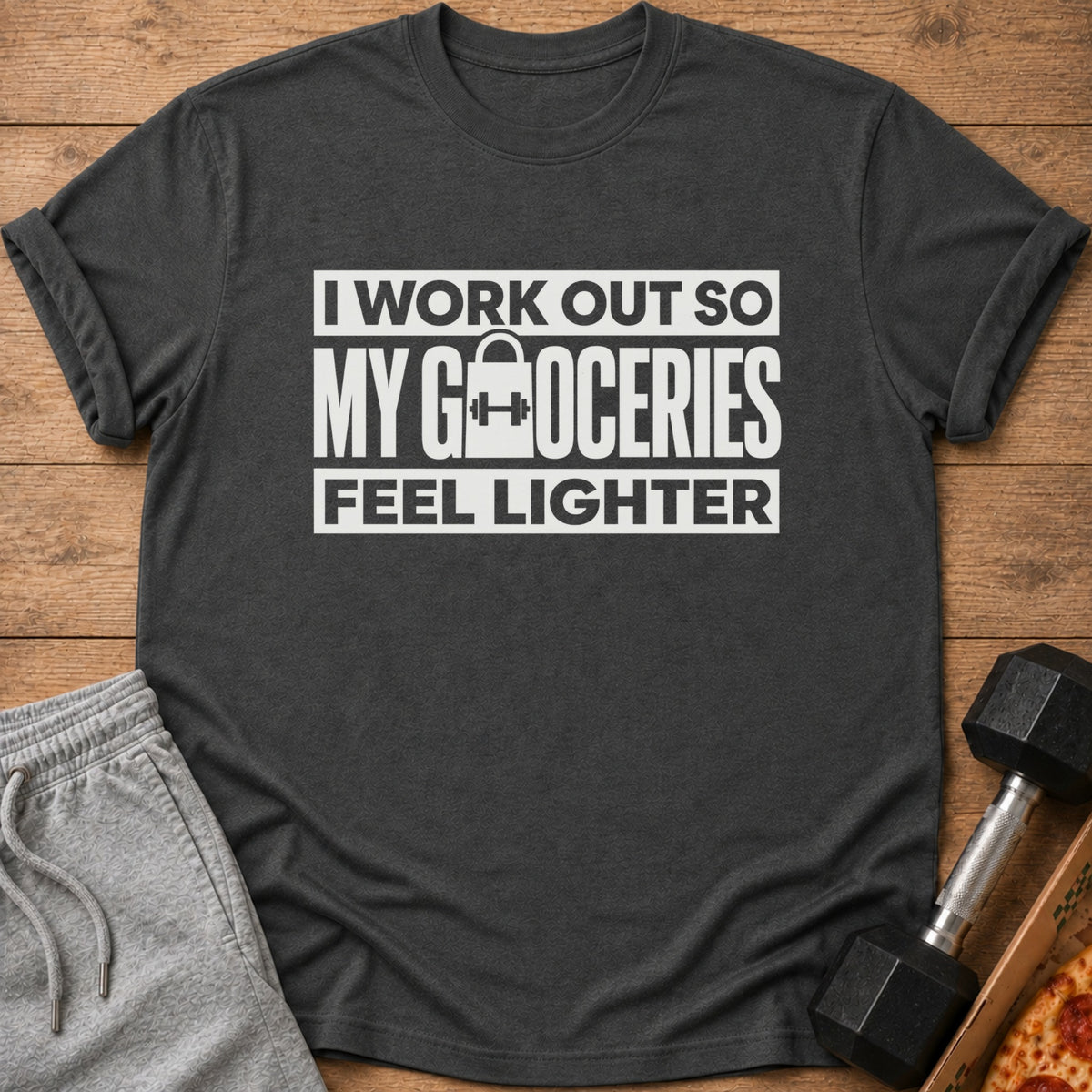 Dark grey t-shirt with white text "I WORK OUT SO MY GROCERIES FEEL LIGHTER".