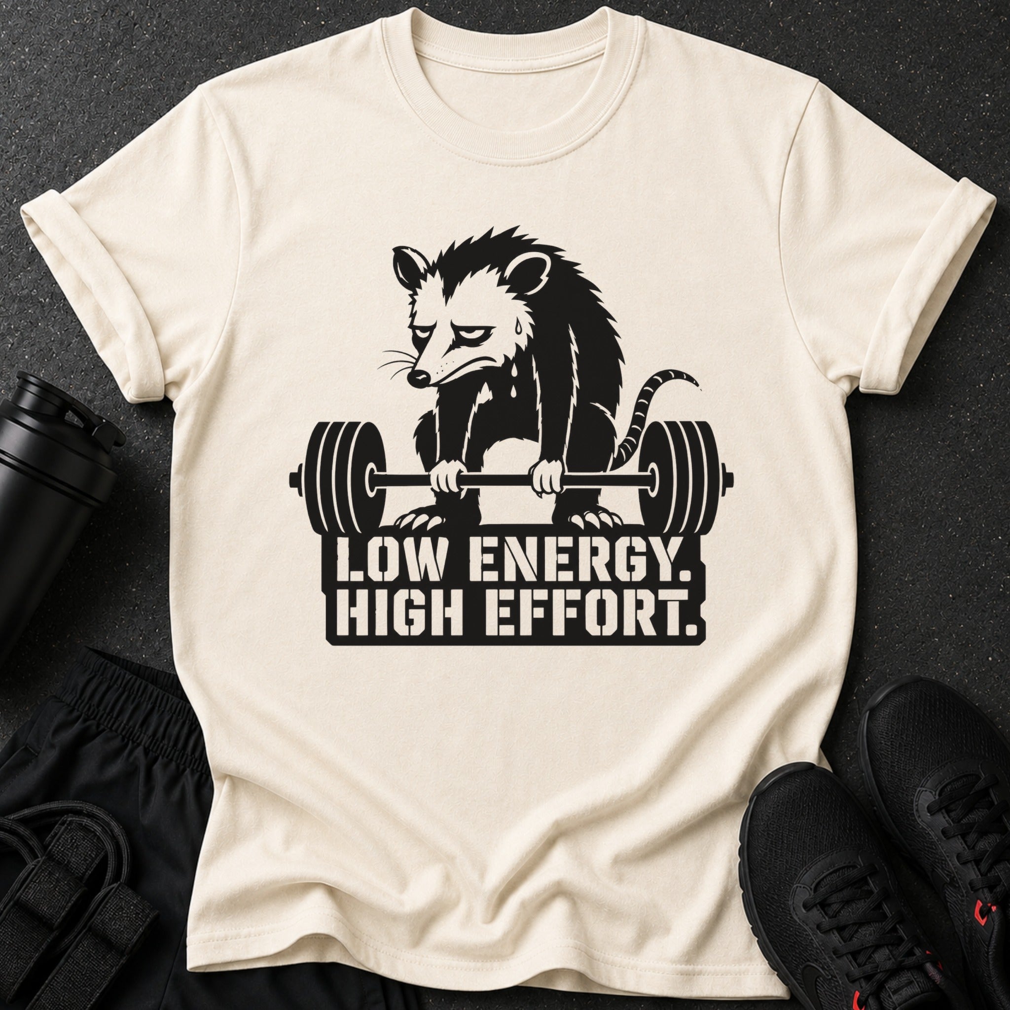 Opossum lifting barbell with text "LOW ENERGY. HIGH EFFORT."