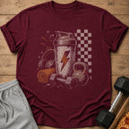 Maroon t-shirt with graphic of gym equipment and lightning bolt.