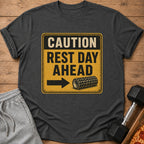 Dark t-shirt with "CAUTION REST DAY AHEAD" text and foam roller graphic.
