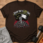 Brown t-shirt with skeleton hand holding flag over weight plates, text "Every Day is Leg Day".