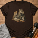 Three kittens play inside a vintage sneaker surrounded by autumn leaves.