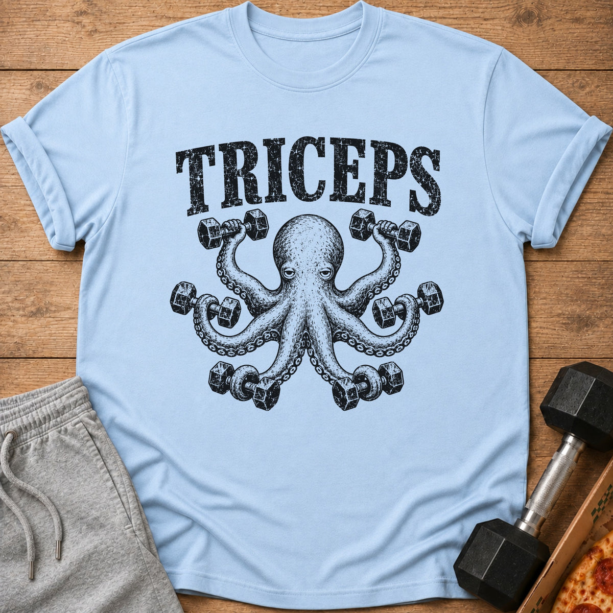 Light blue t-shirt with black graphic of an octopus lifting dumbbells and the word "TRICEPS".
