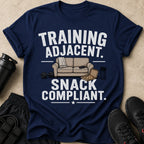 Navy t-shirt with white text "TRAINING ADJACENT. SNACK COMPLIANT." and graphic.